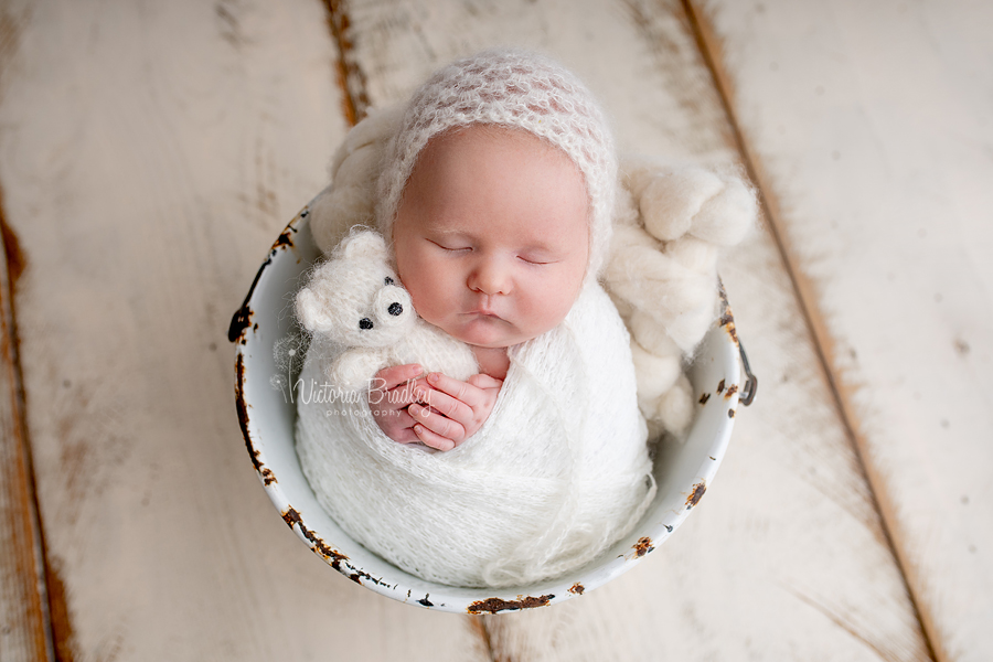 wrapped newborn in white bucket