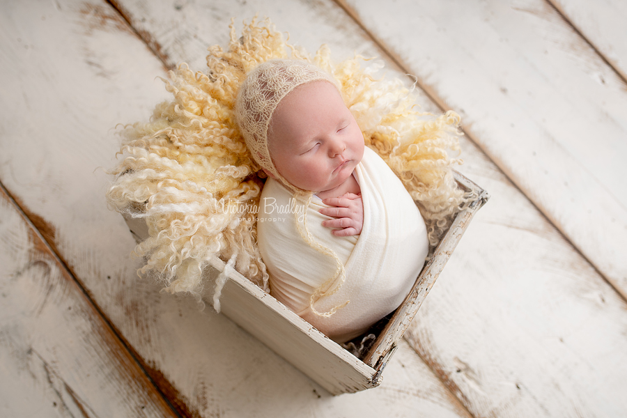 wrapped newborn in pale yellow