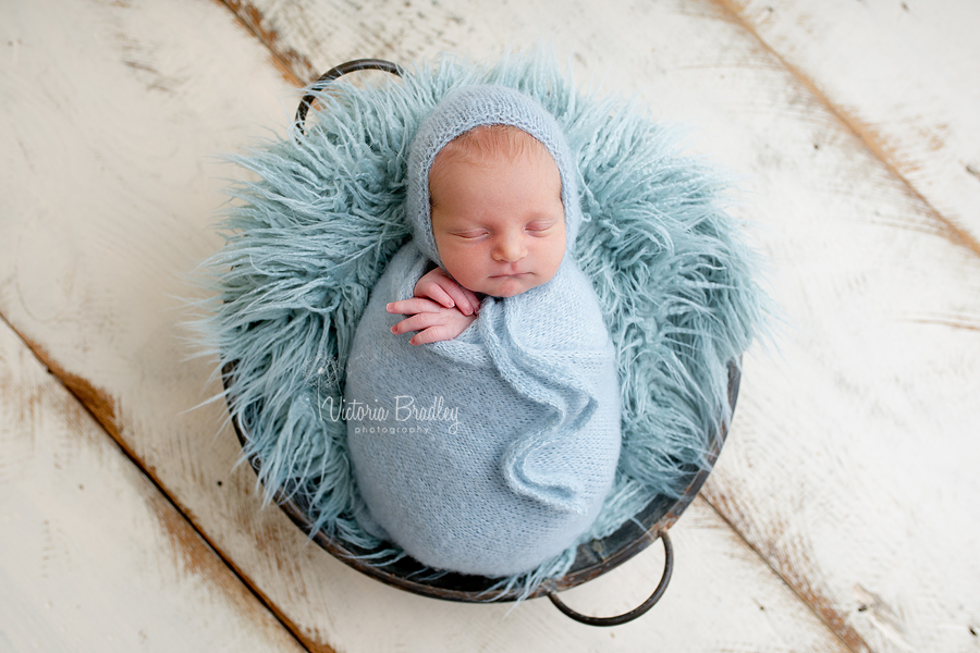 swaddled baby in duck egg blue wrap