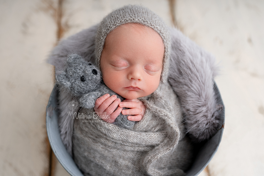 baby boy holding teddy