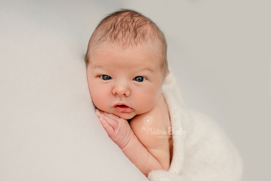 awake newborn on tummy