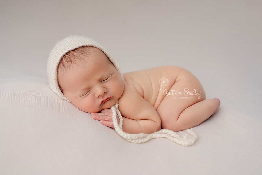 sleepy newborn on tummy