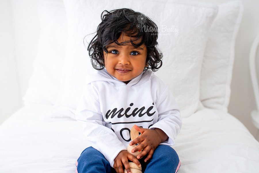 baby girl on white bed set up