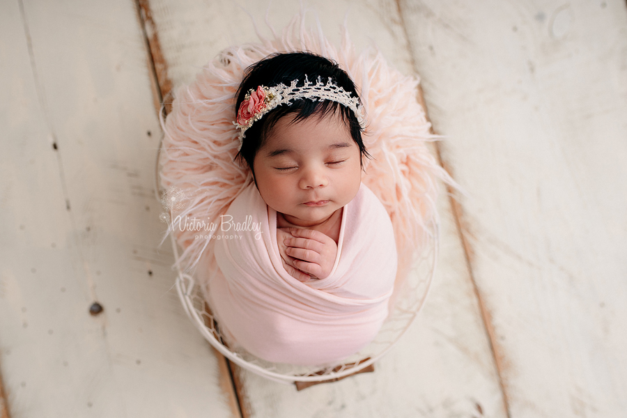 swaddled newborn photography baby in peach