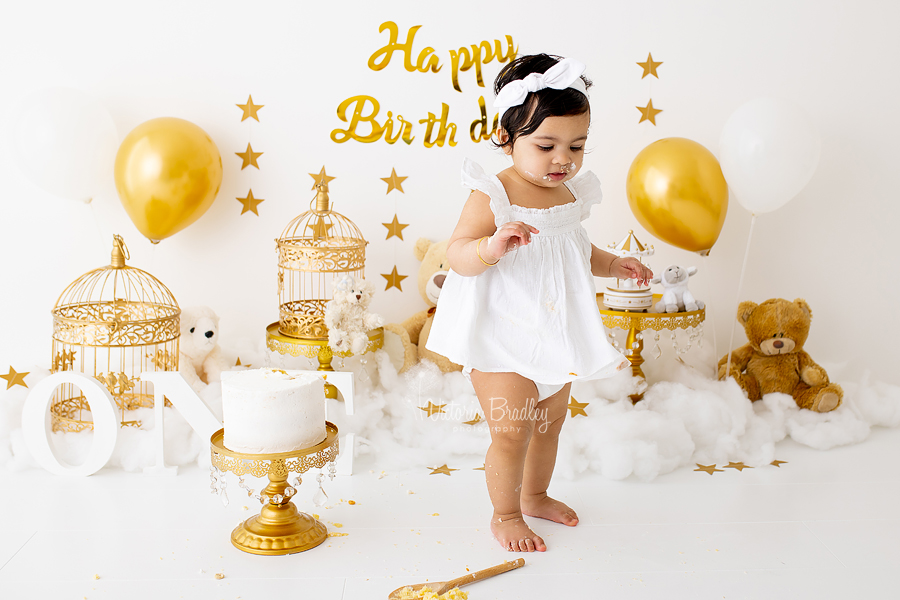 gold and white baby girl cake smash