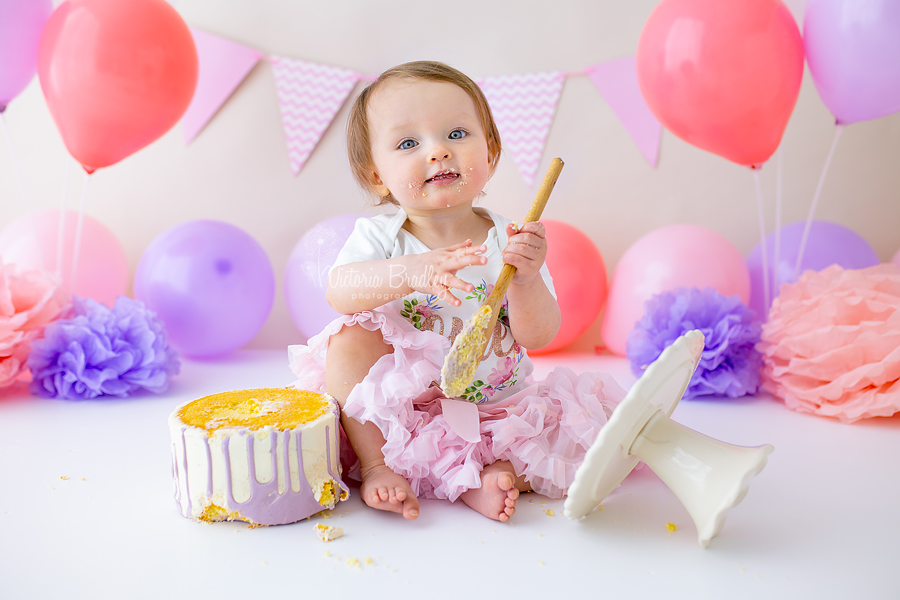 pink and purple baby girl cake smash