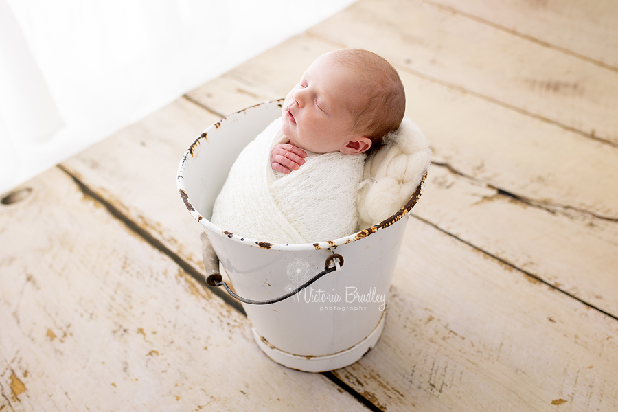 wrapped newborn in bucket