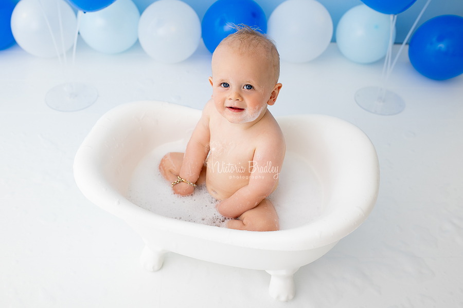 baby boy in bath tub cakes mash blues