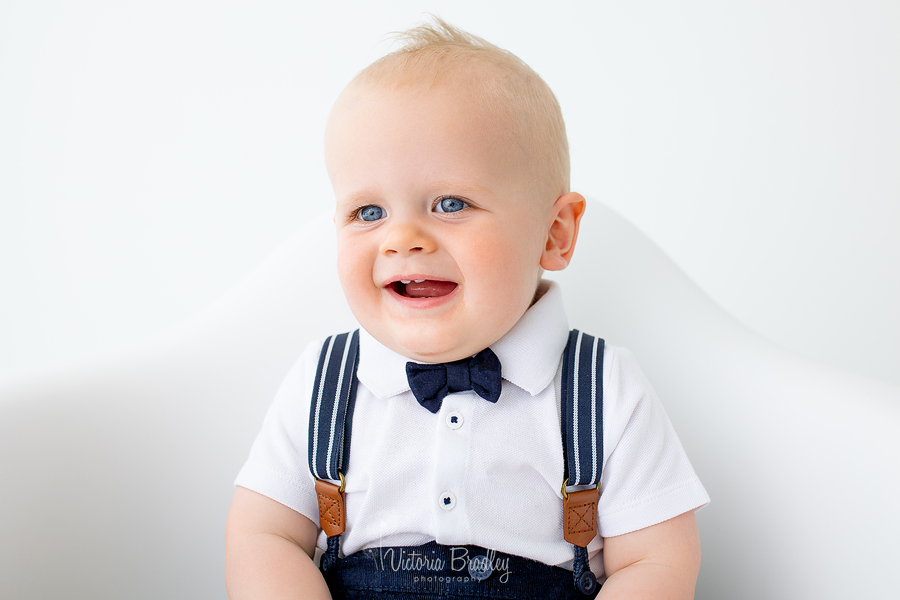 baby boy in bow tie smiling