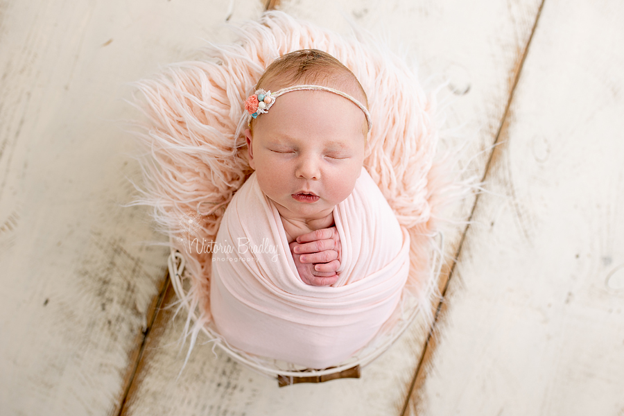 wrapped newborn in peach photography