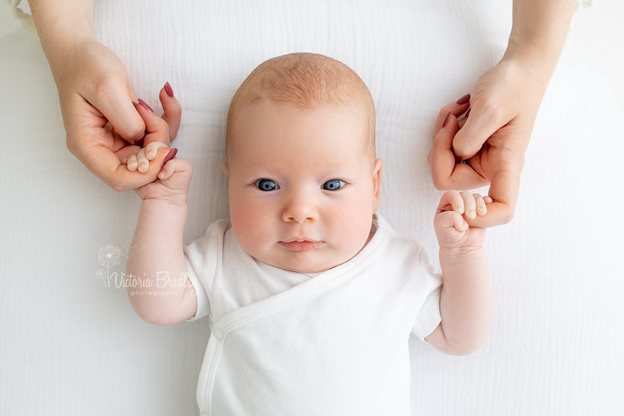 baby holding mummy's hands