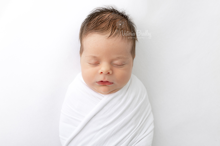 swaddled newborn boy