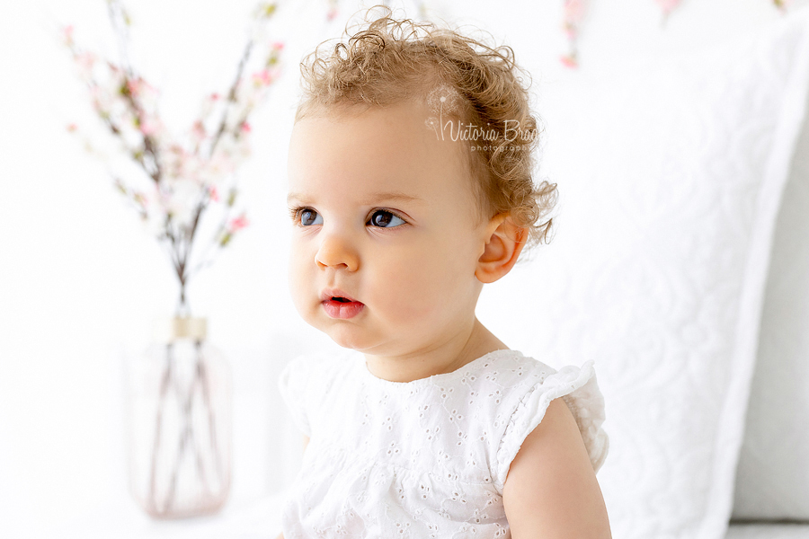 close up of baby on white with blossom