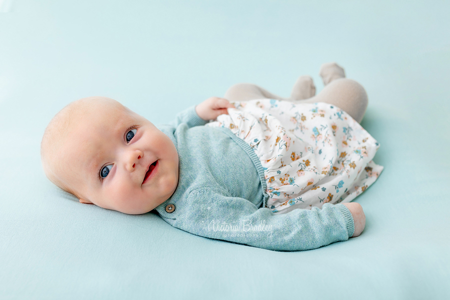 newborn on blue backdrop