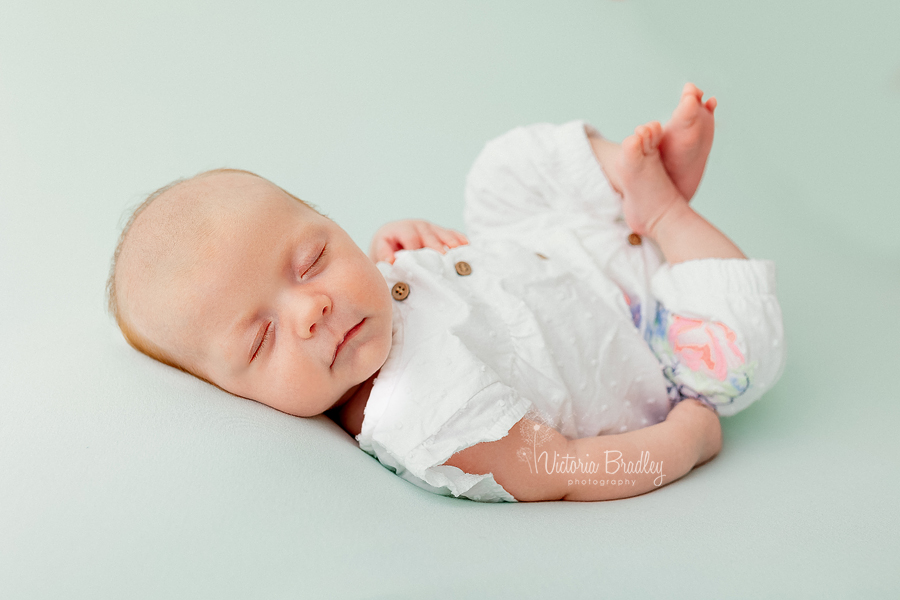 baby girl newborn on green backdrop