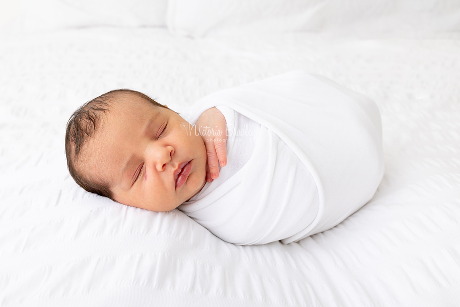 wrapped newborn in white