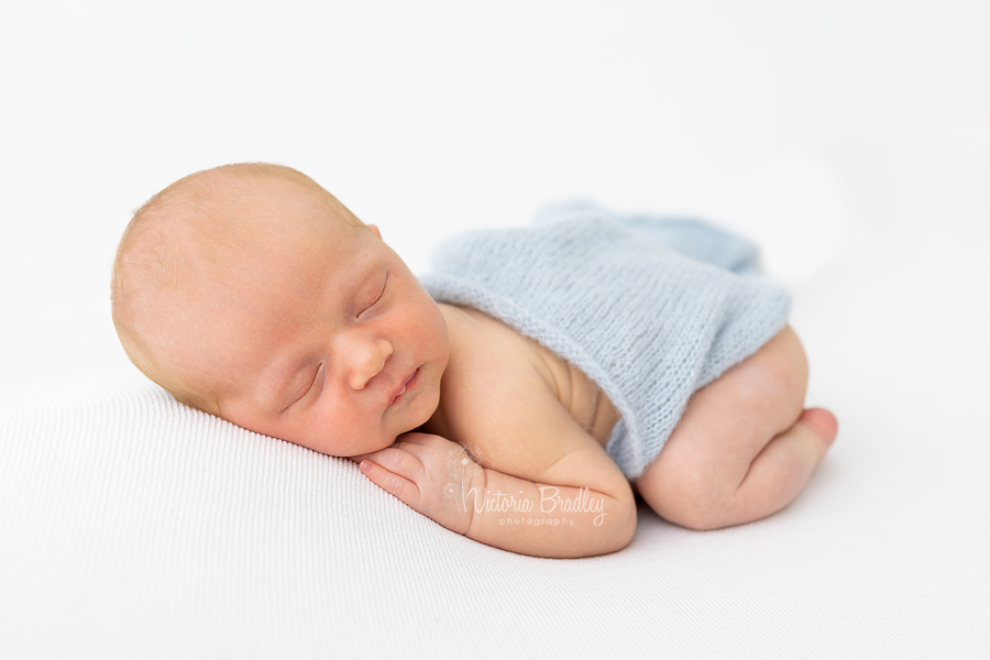 baby boy on white blanket