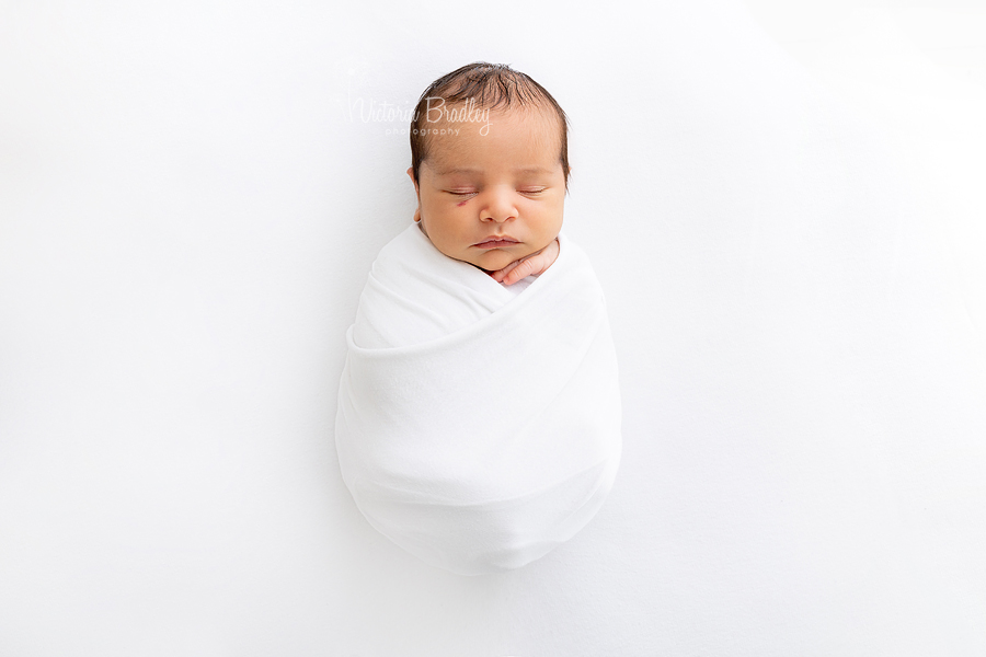 wrapped newborn in white