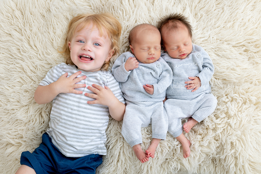 newborn twins with sibling