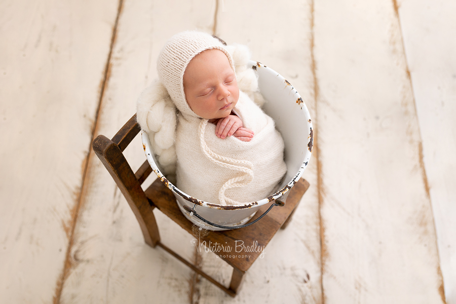 wrapped baby boy in bucket