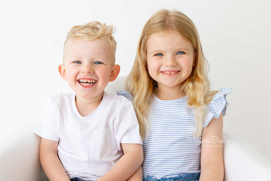 siblings sat in a chair