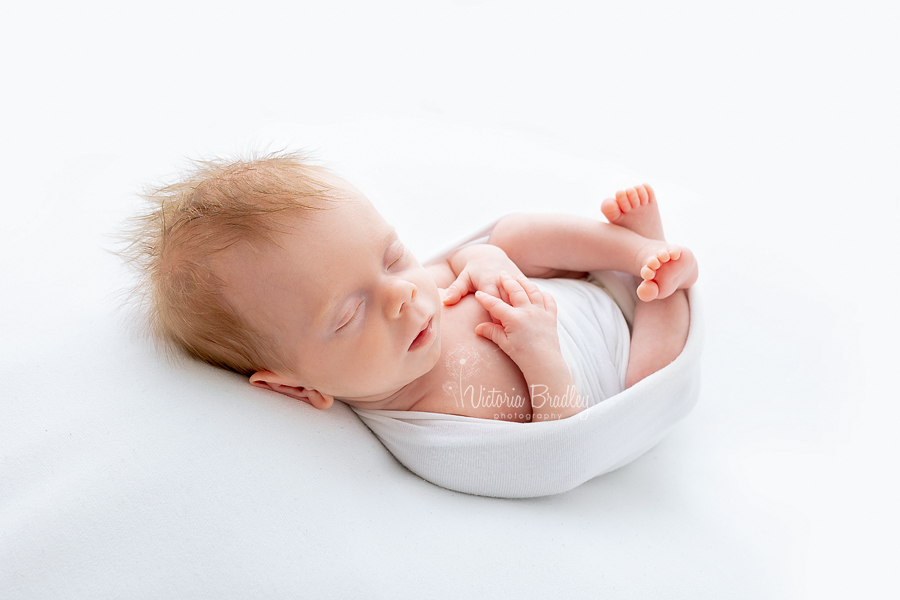 wrapped newborn in white