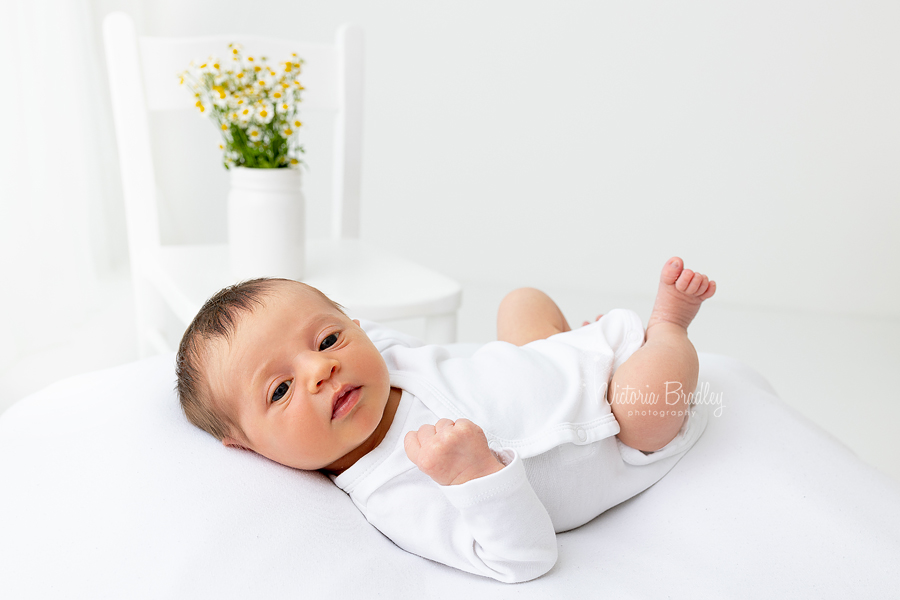 Newborn on white with Daisies