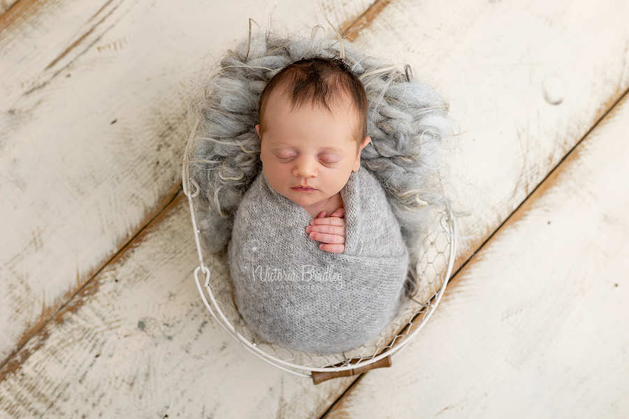 wrapped baby girl in grey, new born