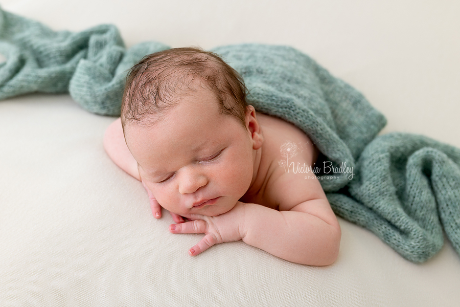 sleepy newborn chin on hands pose