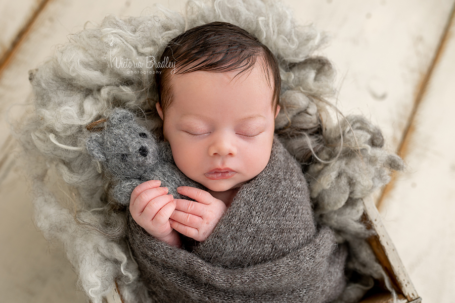 wrapped newborn in grey