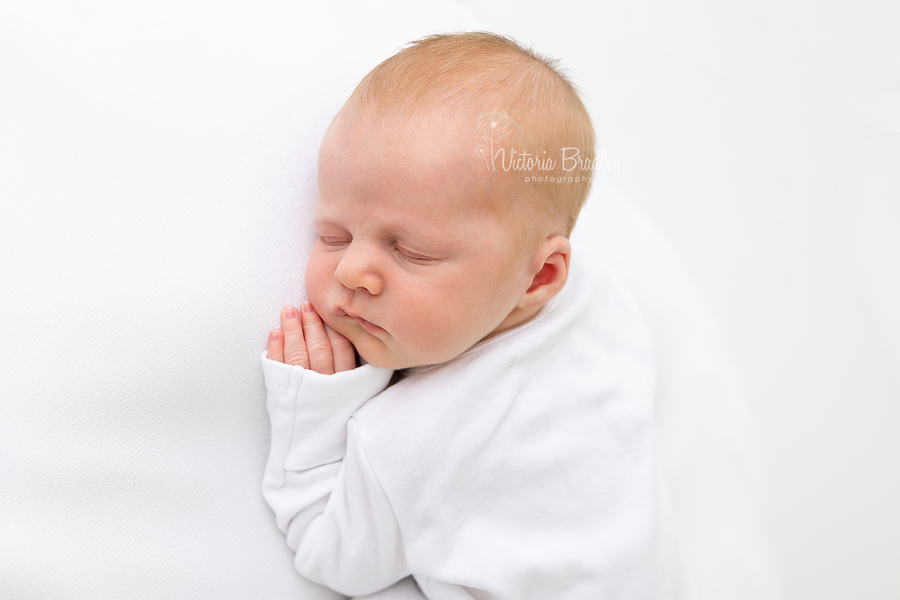 sleepy newborn on white