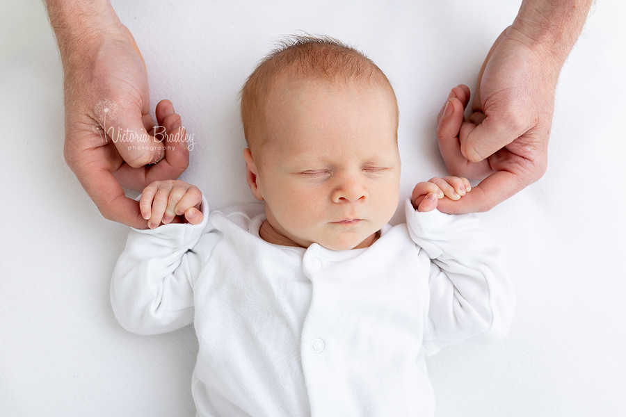 newborn and Daddy's hands