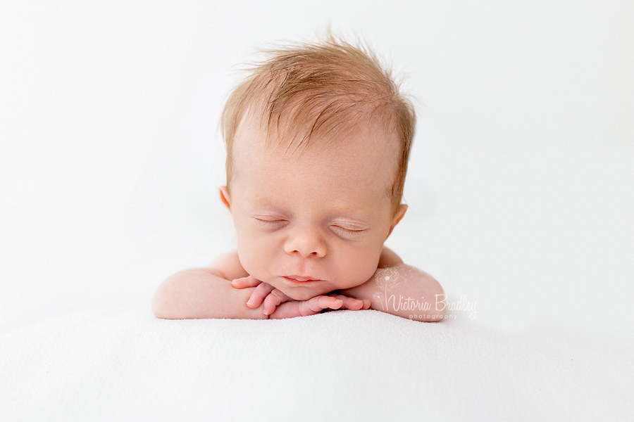 chin on hands newborn pose