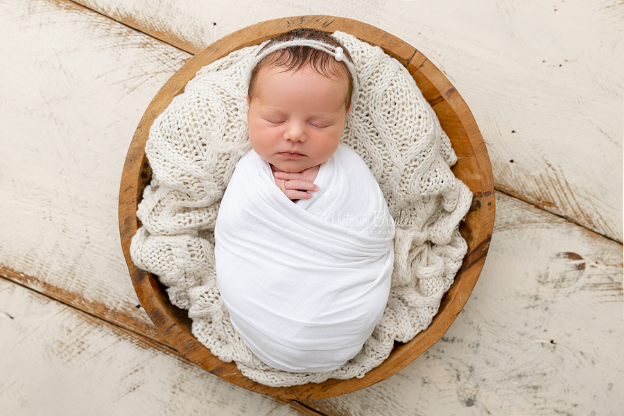 wrapped newborn photography in wooden bowl