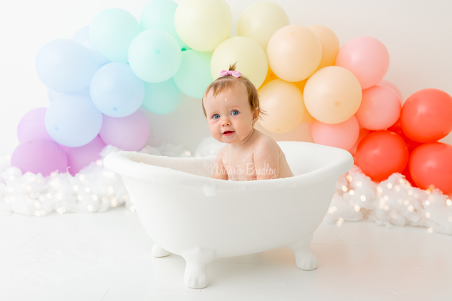 baby girl in tub cake smash