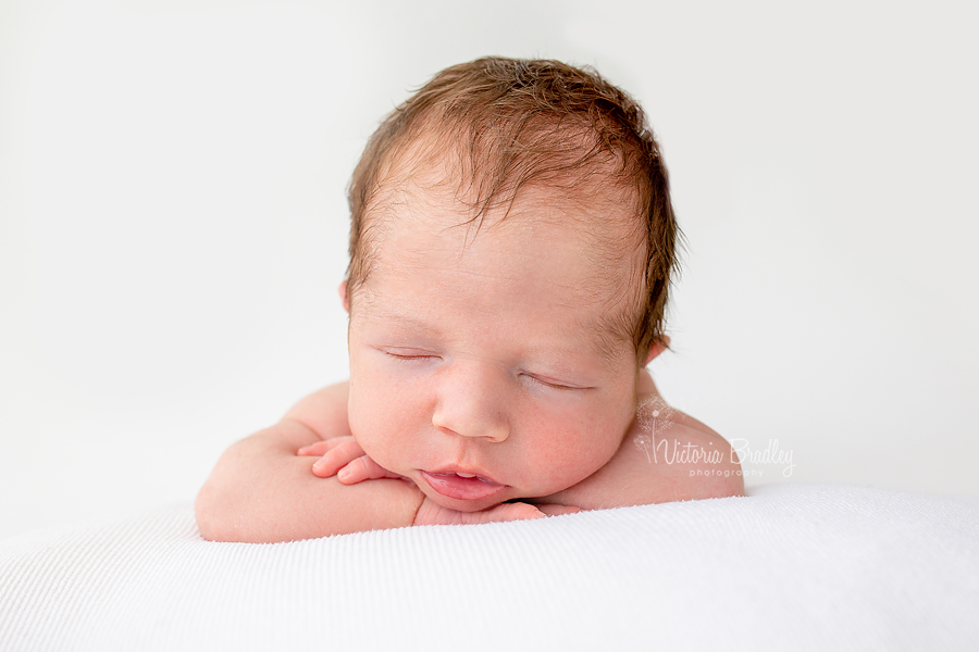 newborn chin on hands pose