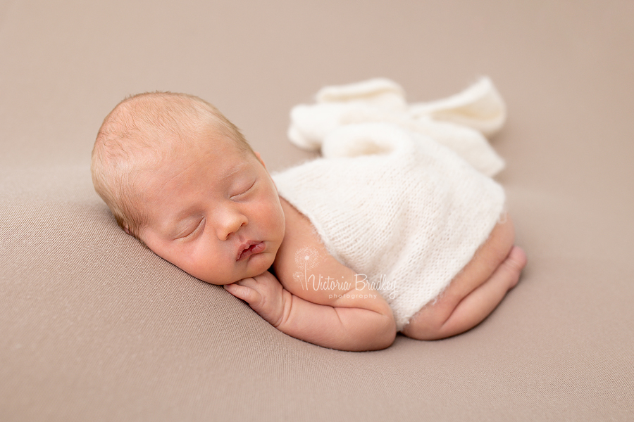 baby boy newborn asleep on tummy