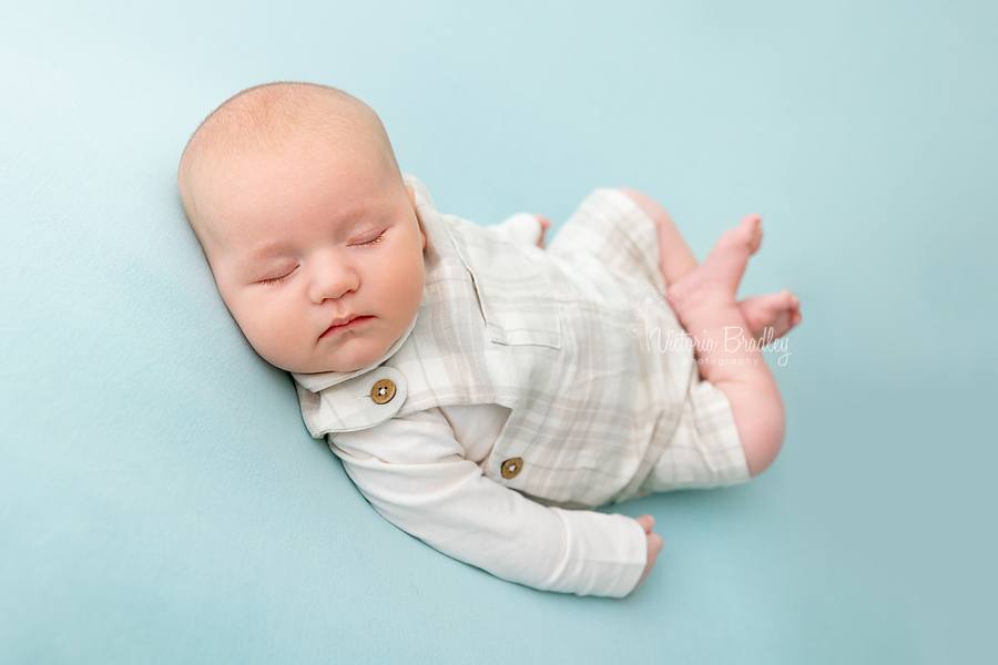 asleep older newborn on blue