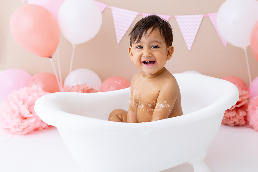 smiley baby in bath tub