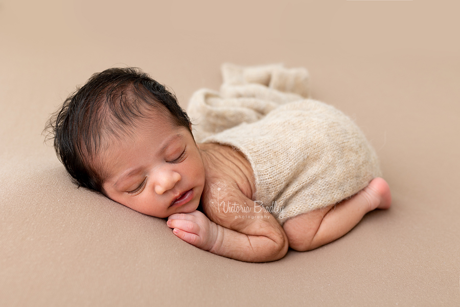 sleepy newborn on tummy