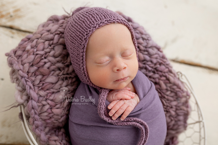 wrapped newborn in purple wrap
