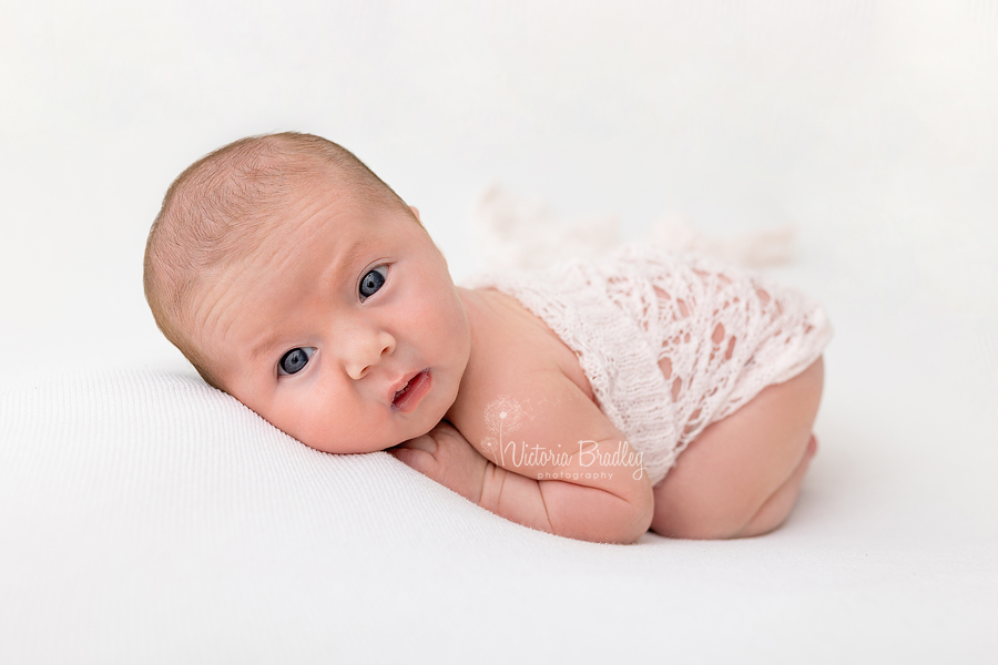 awake newborn on tummy