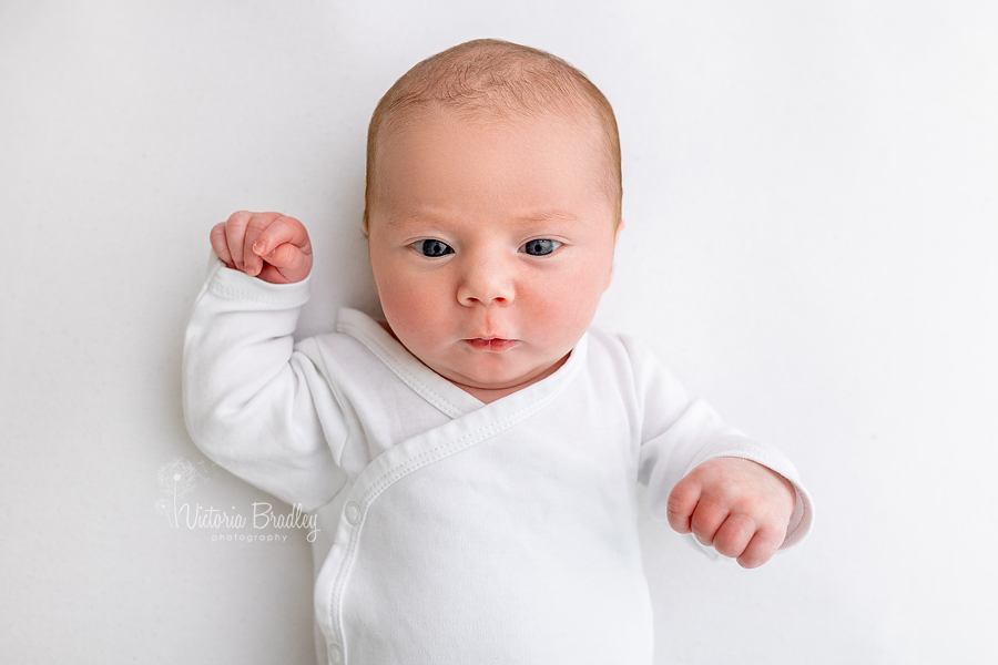 baby girl newborn on white backdrop