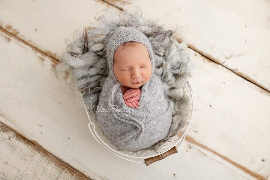 wrapped newborn on grey