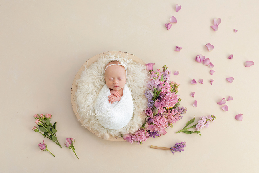 wrapped newborn in flower basket