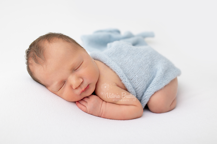 sleepy newborn on tummy