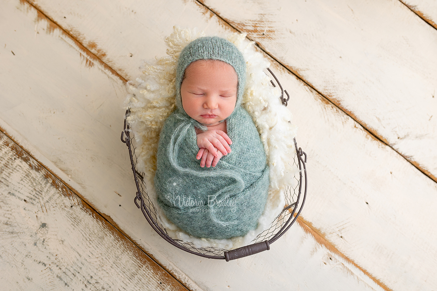 wrapped newborn baby in green
