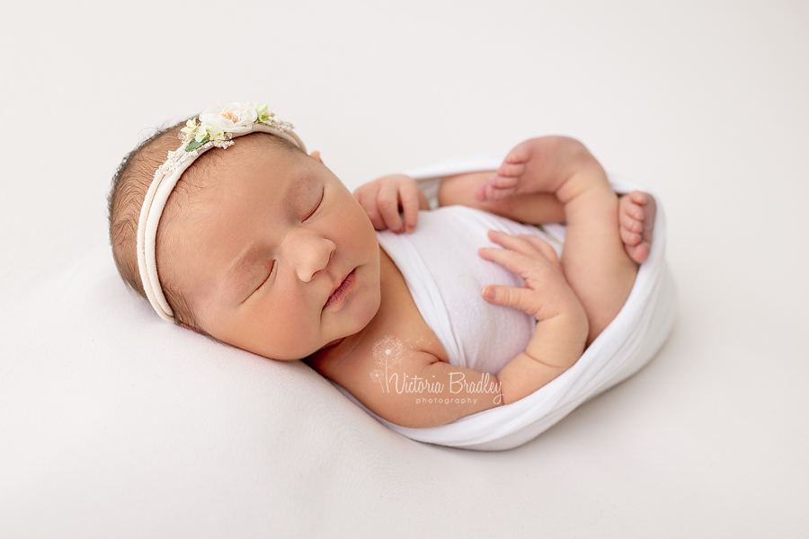 wrapped newborn with flower tieback