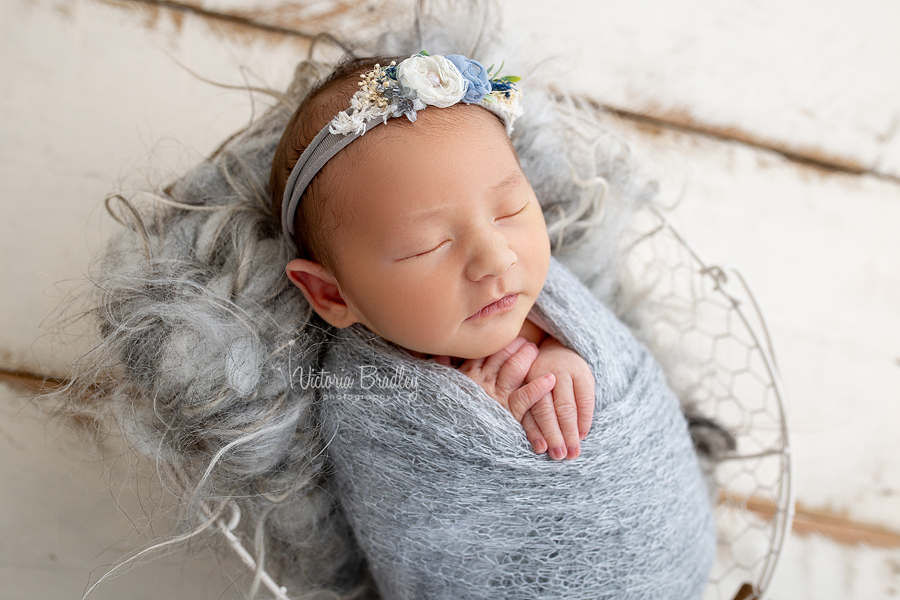 wrapped baby girl in grey photograph