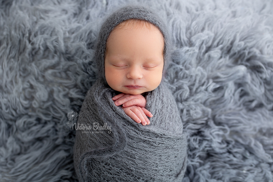 wrapped baby in grey